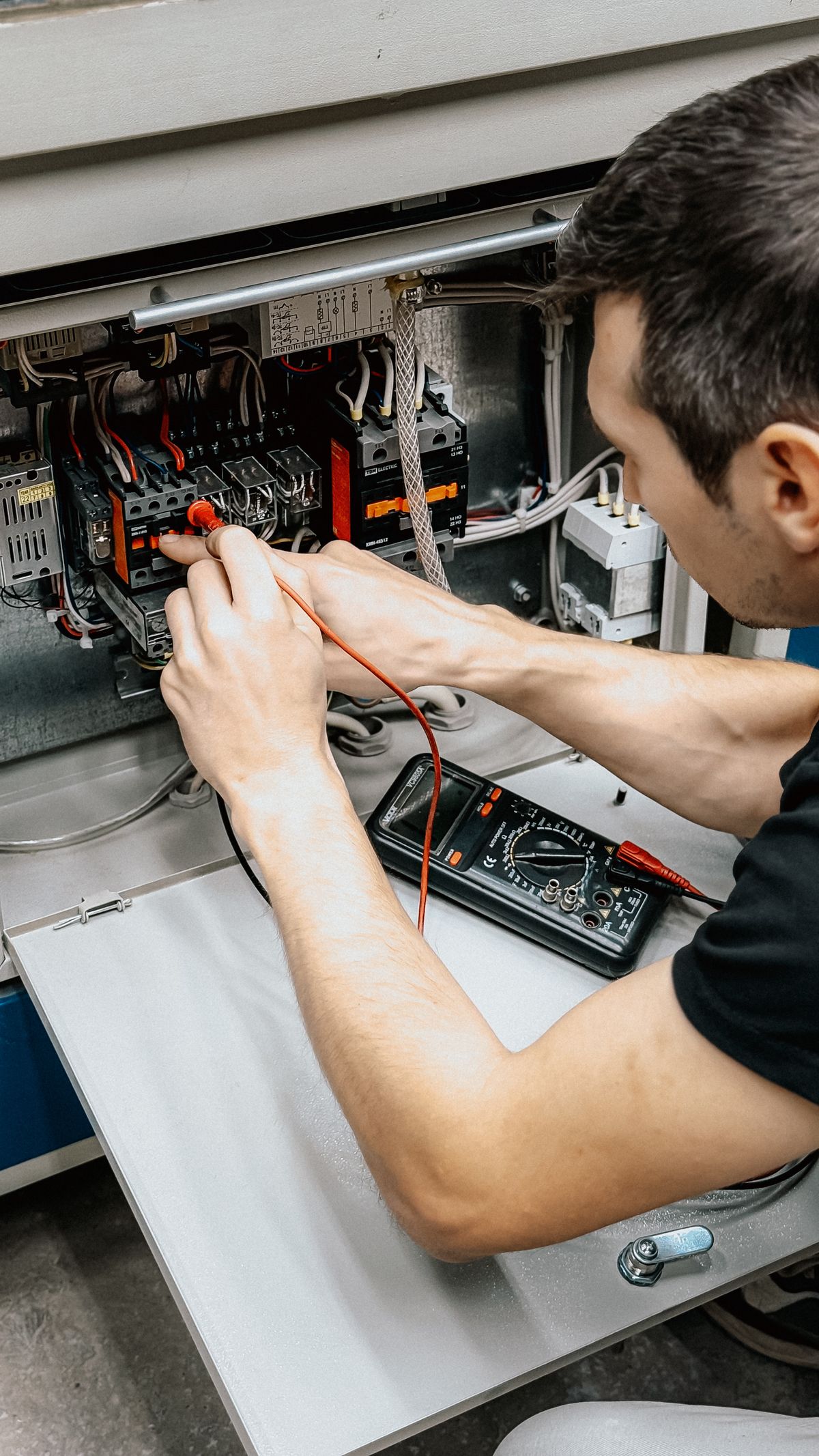 Electrician testing an electrical panel
